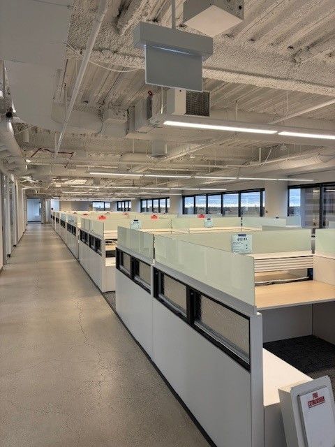 A long hallway with cubicles in a large office