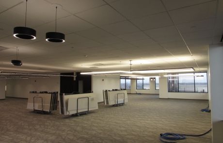 A large empty room with a vacuum in the middle