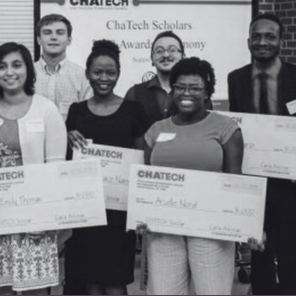 A group of people holding checks that say chatech
