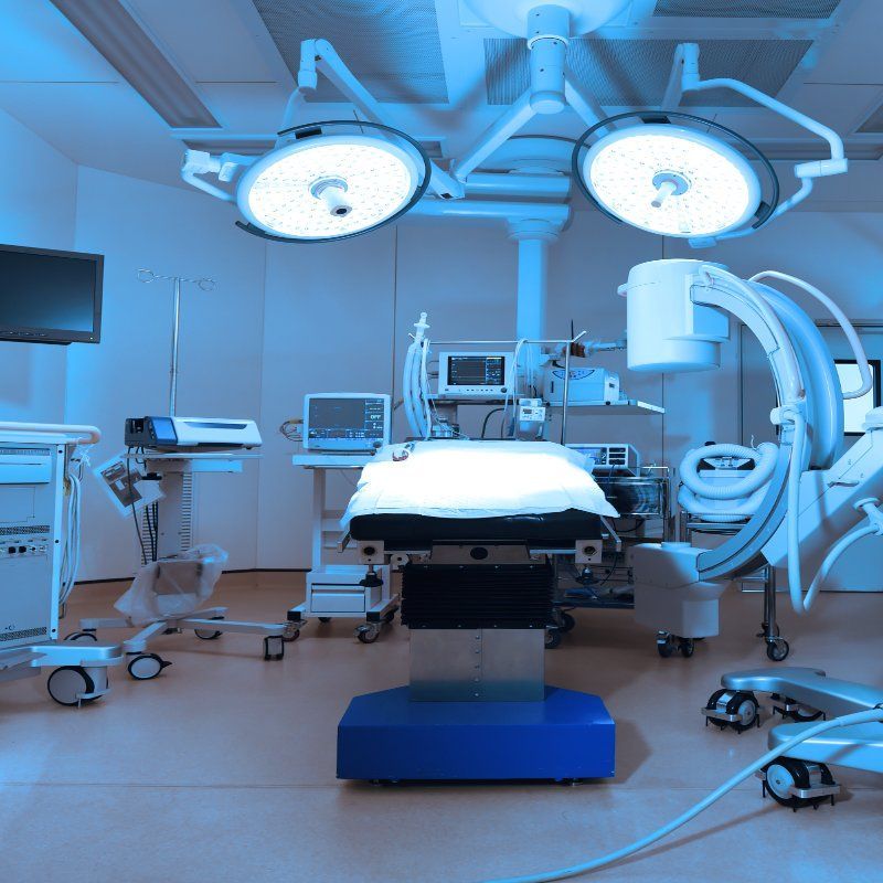 An operating room with a bed and lots of medical equipment