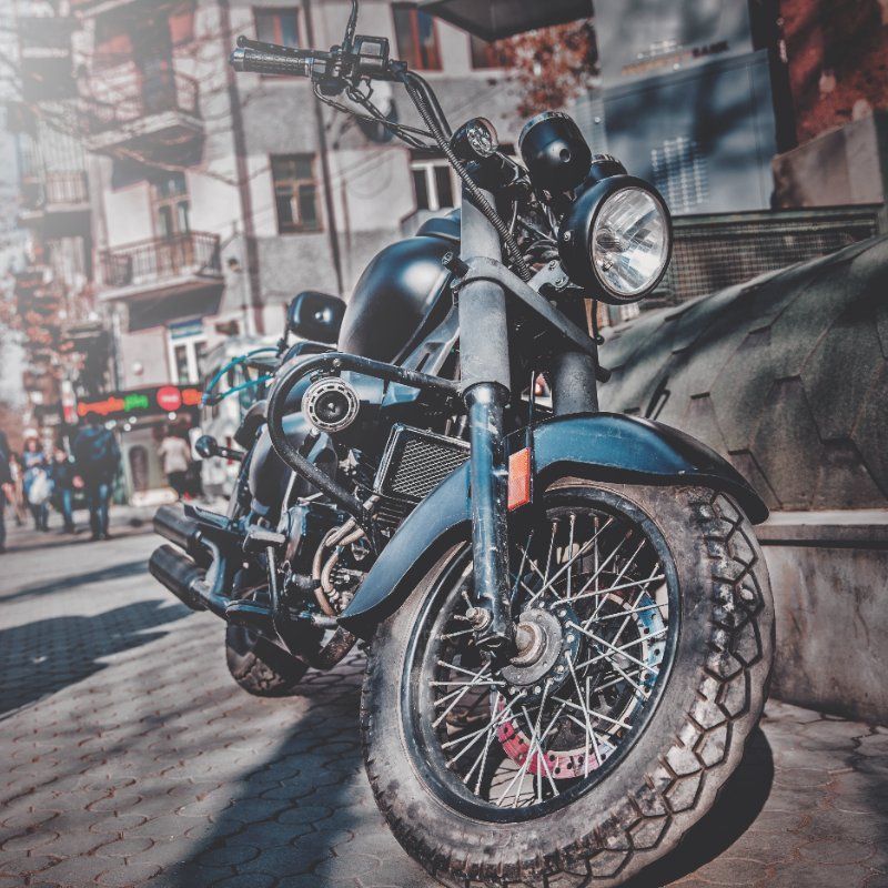 A black motorcycle is parked on the side of the road