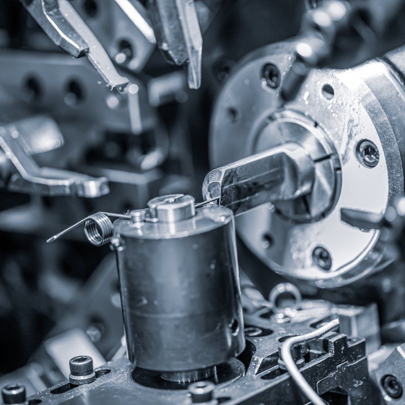 A machine is working on a piece of metal in a factory.