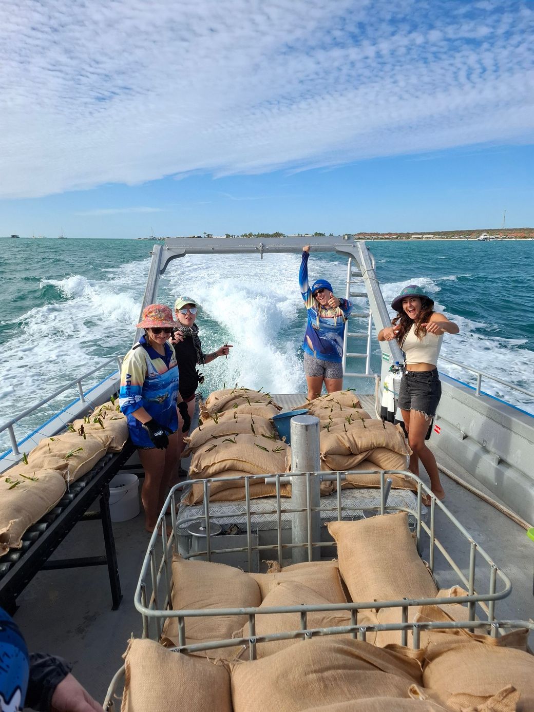 A boat is floating on top of a body of water in shark bay