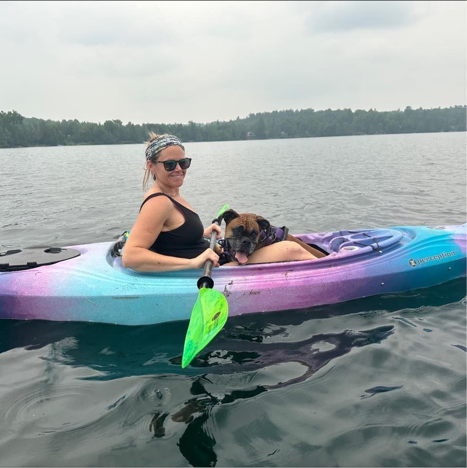 Joni kayaking with her pup
