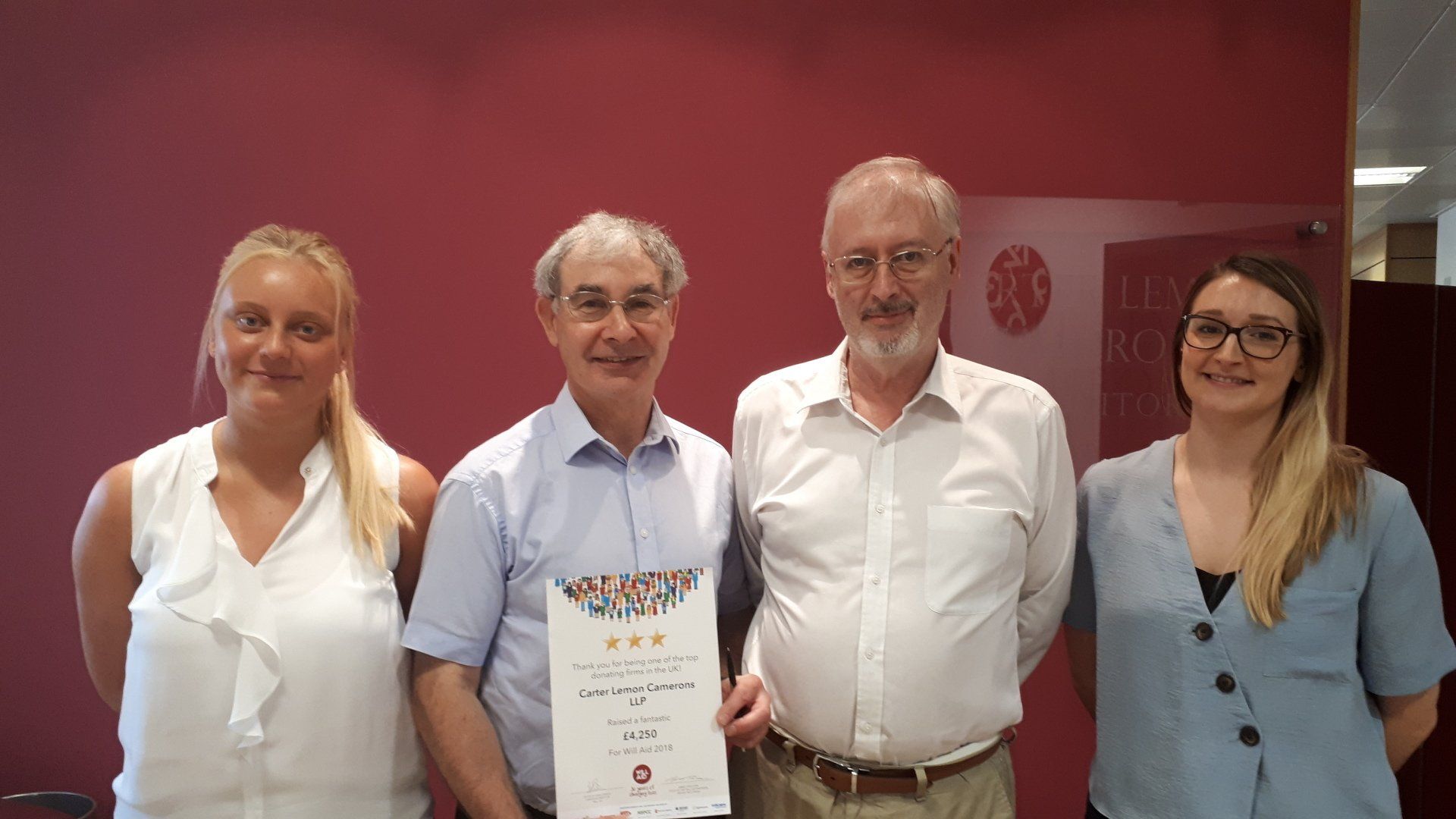 A group of people standing next to each other holding a certificate.