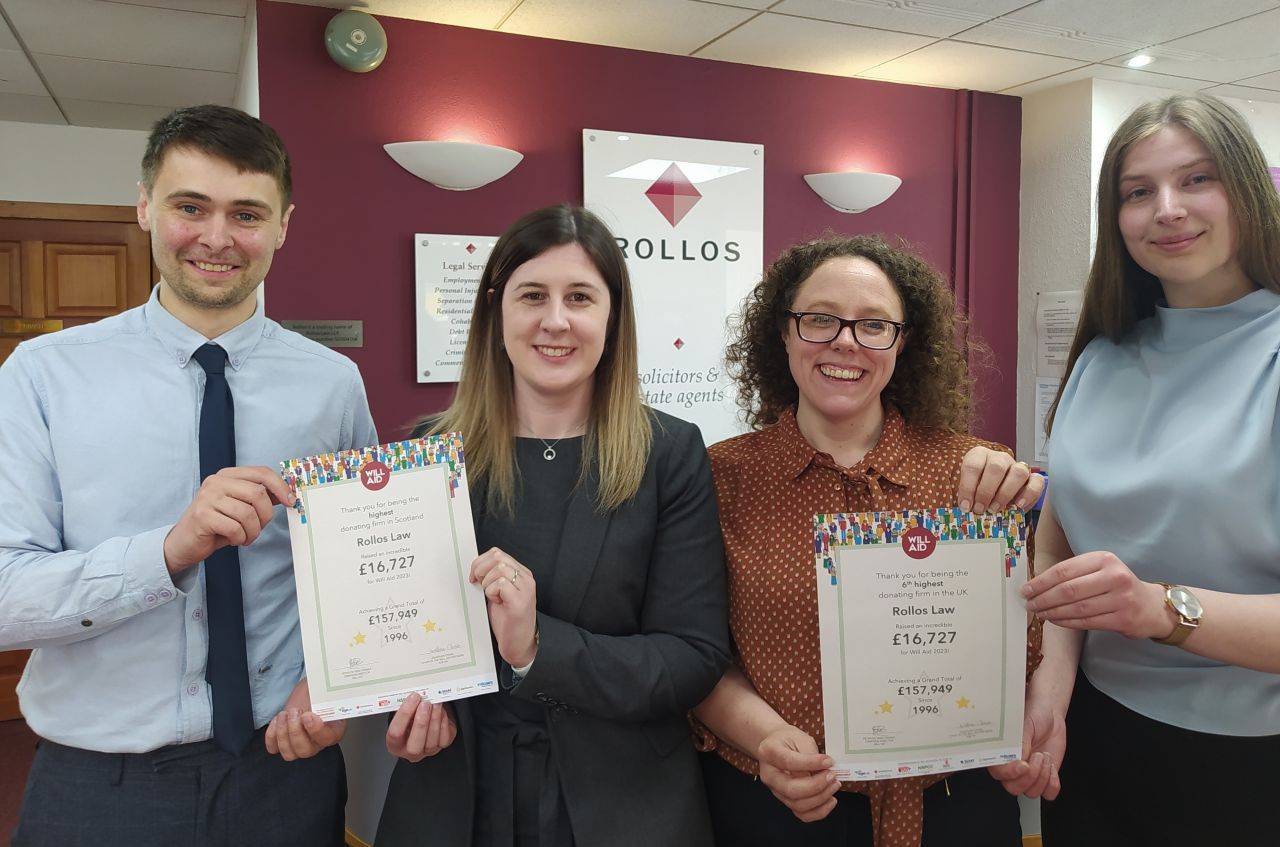 A group of people are standing next to each other holding certificates.