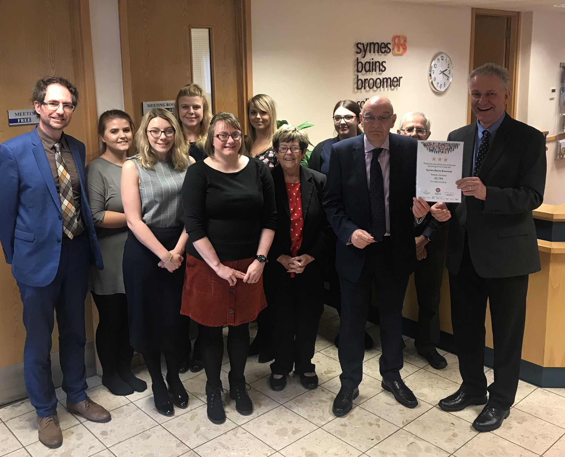 A group of people are posing for a picture in a room.