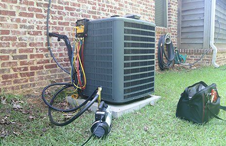 Air Conditioning Repair — Air Conditioner Maintenance with Gauges and Vacuum Pump in Concord, NC