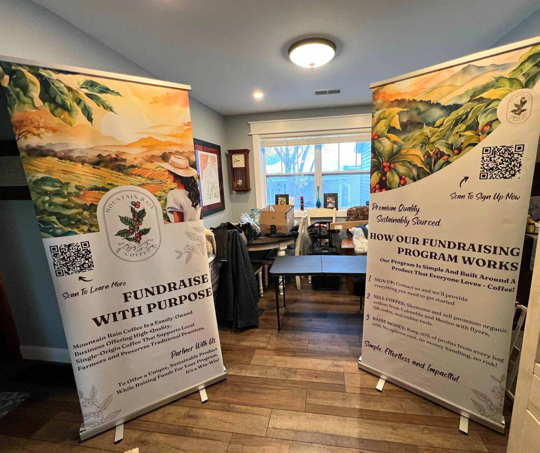 Two banners are sitting on a wooden floor in a room.