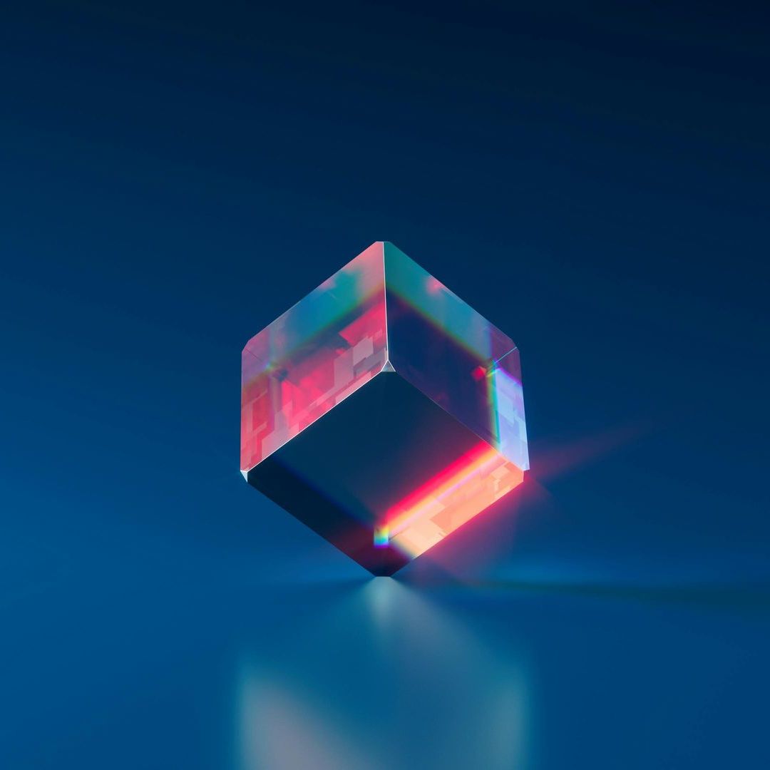A colorful cube is sitting on a blue surface.