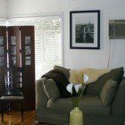 A living room filled with furniture and a picture on the wall.