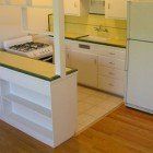 A kitchen with a refrigerator , stove , sink , and dishwasher.