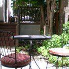 A table and chairs are sitting on a patio in a garden.