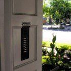 A close up of a door with a mailbox on it.