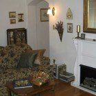 A living room with a couch , chair , table and fireplace.