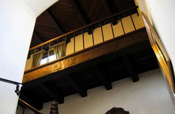 Looking up at a staircase with a wooden railing