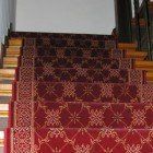 A set of stairs with a red carpet on them.