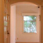 A hallway with a door and a window in a house.