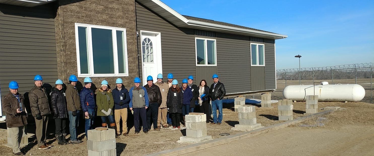 ICOG picture of tour of prison built housing