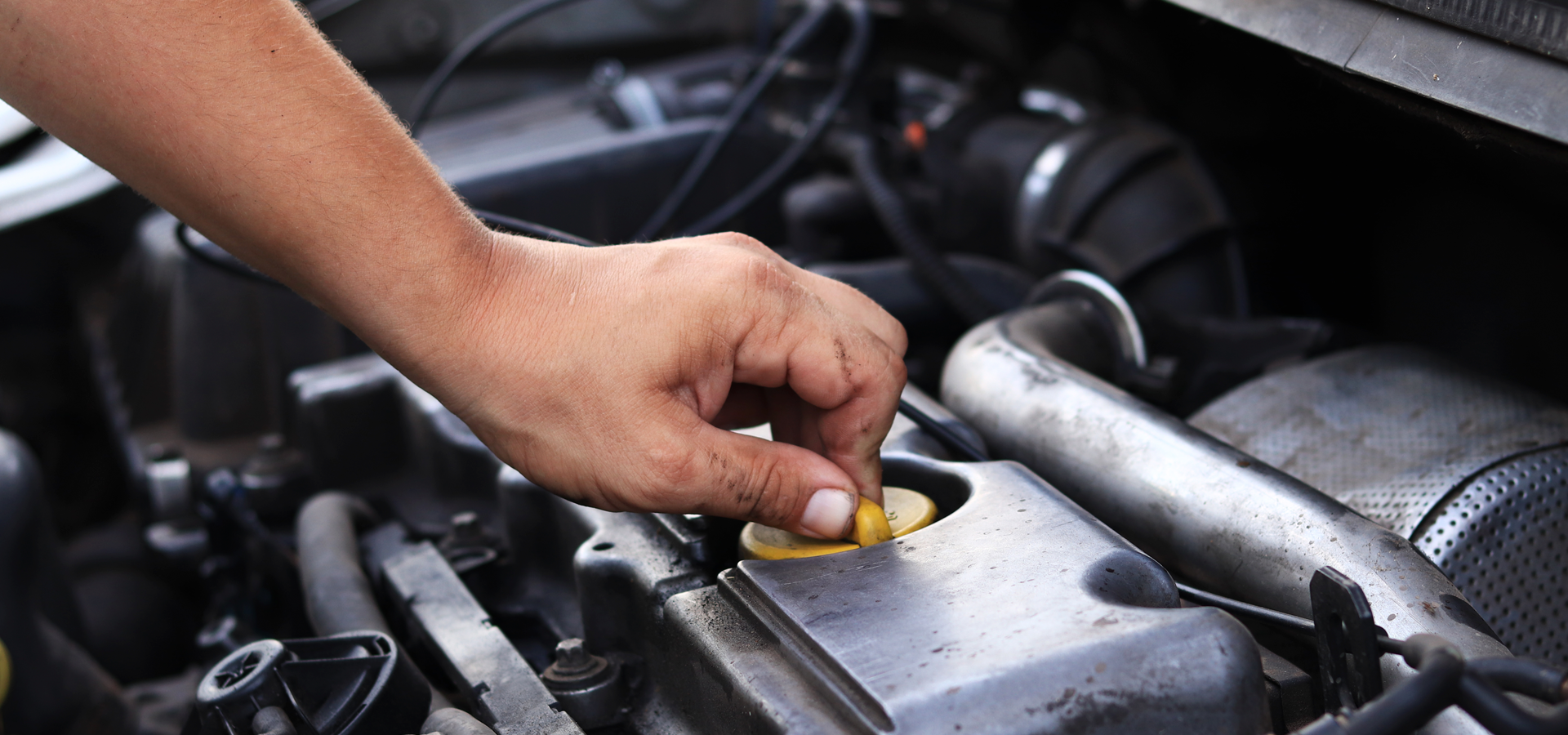 Technician checking oil level on Honda vehicle