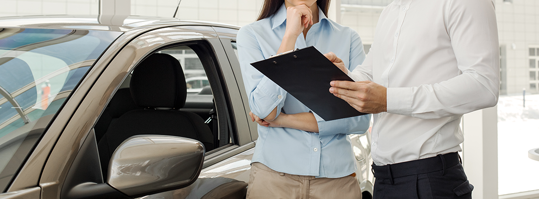 Mechanic checking brakes during used car inspection