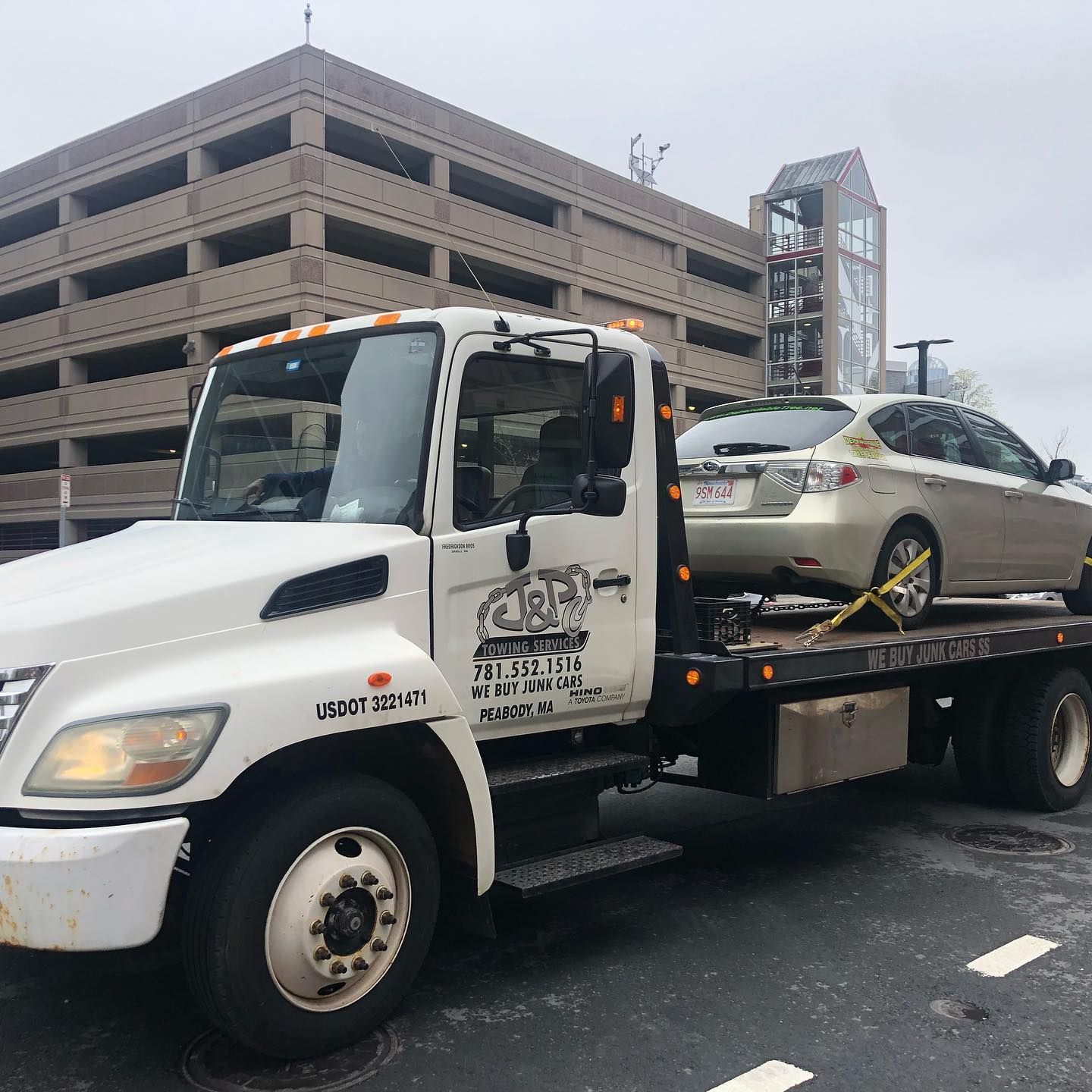 A tow truck with a car on the back of it