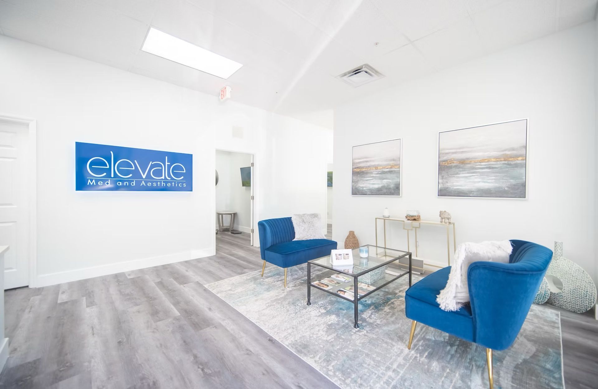 A living room with two blue chairs and a coffee table.