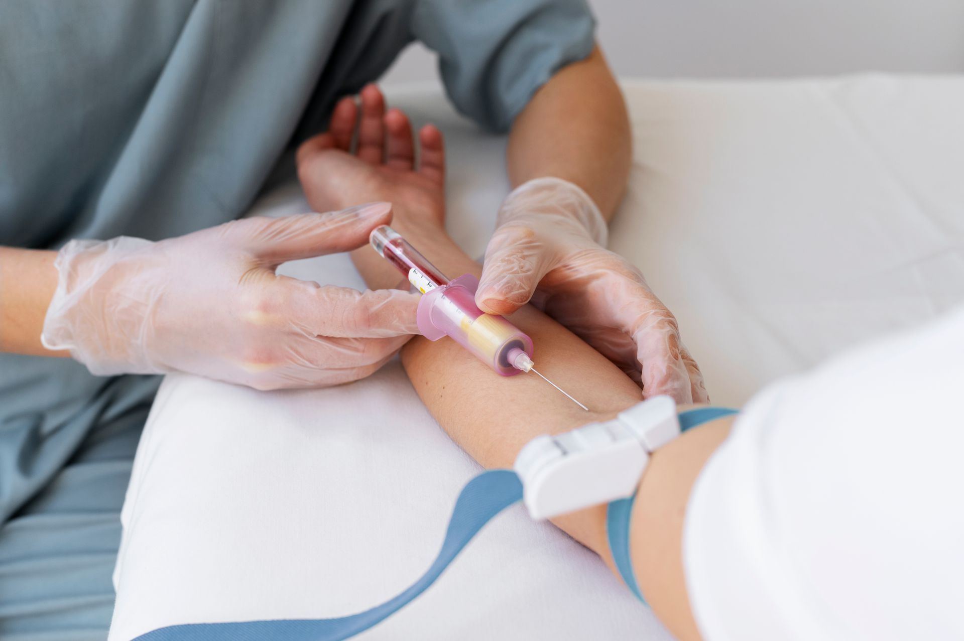 a doctor drawing blood from a man.