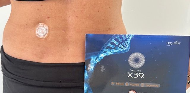 A woman with a patch on her stomach is holding a box of x39.