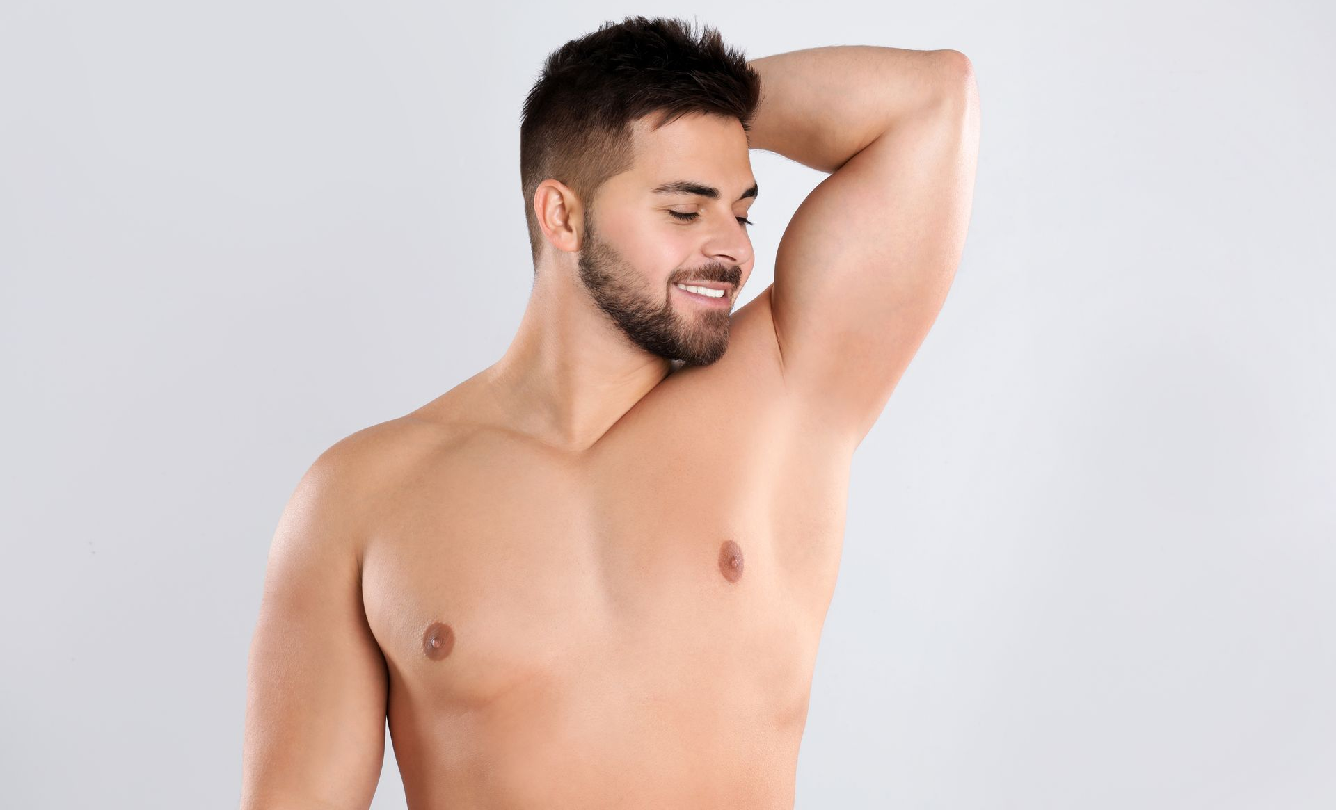 A woman is sitting on a bed with her legs crossed.