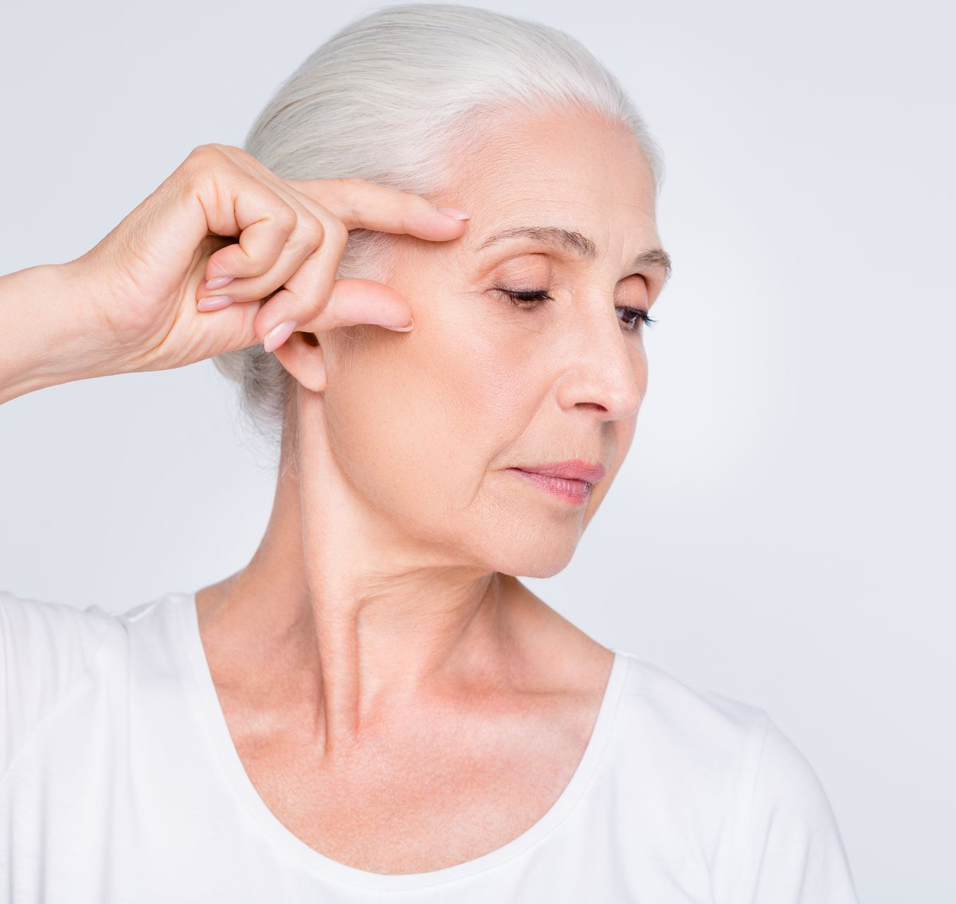 A woman is getting a botox injection in her face.