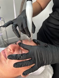 A woman is getting a facial treatment at a spa.
