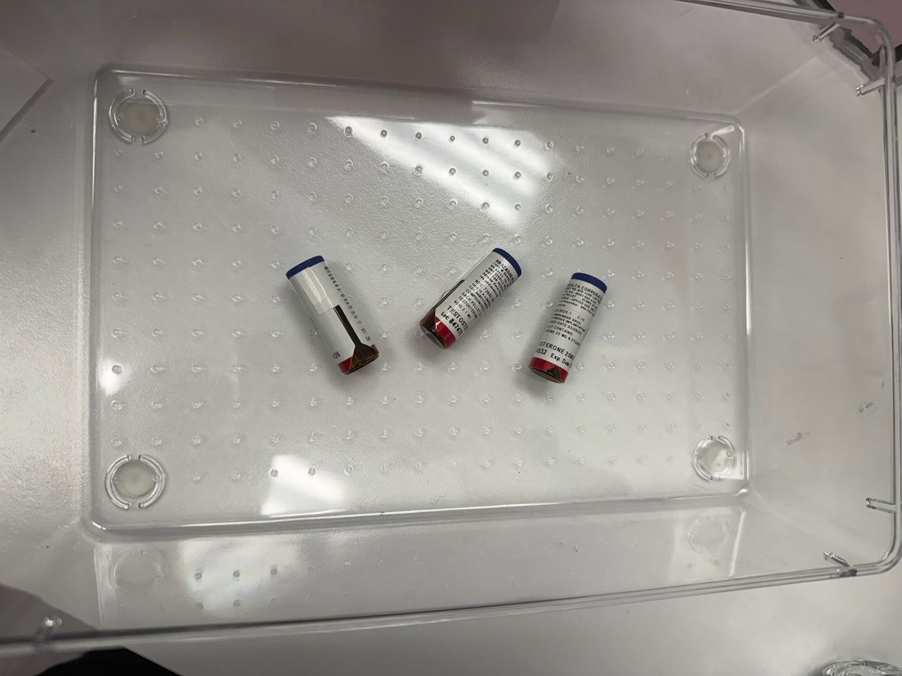 A woman is laying in a bed getting an injection from a doctor.