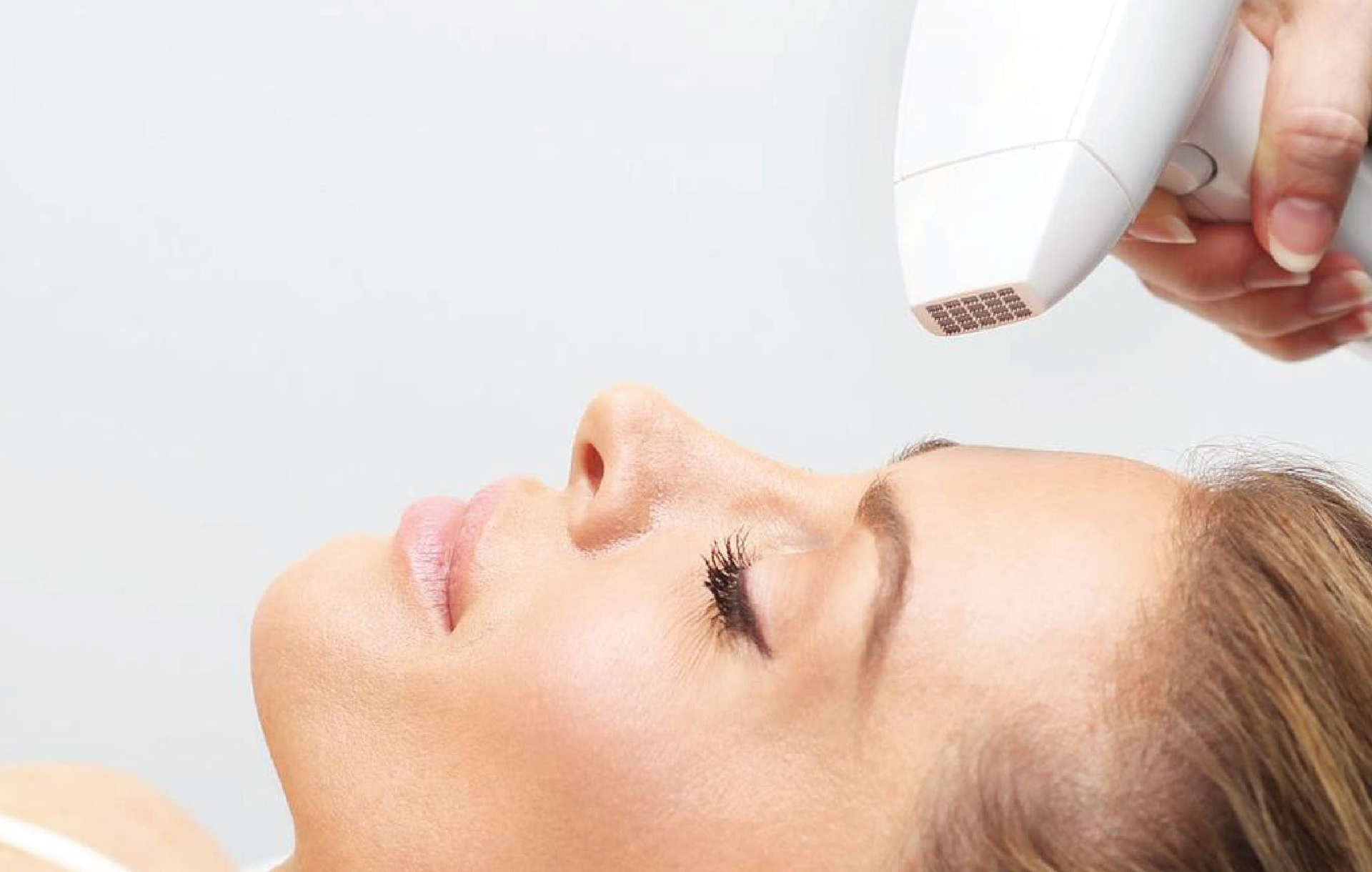 Portrait of a smiling woman touching her face over white background