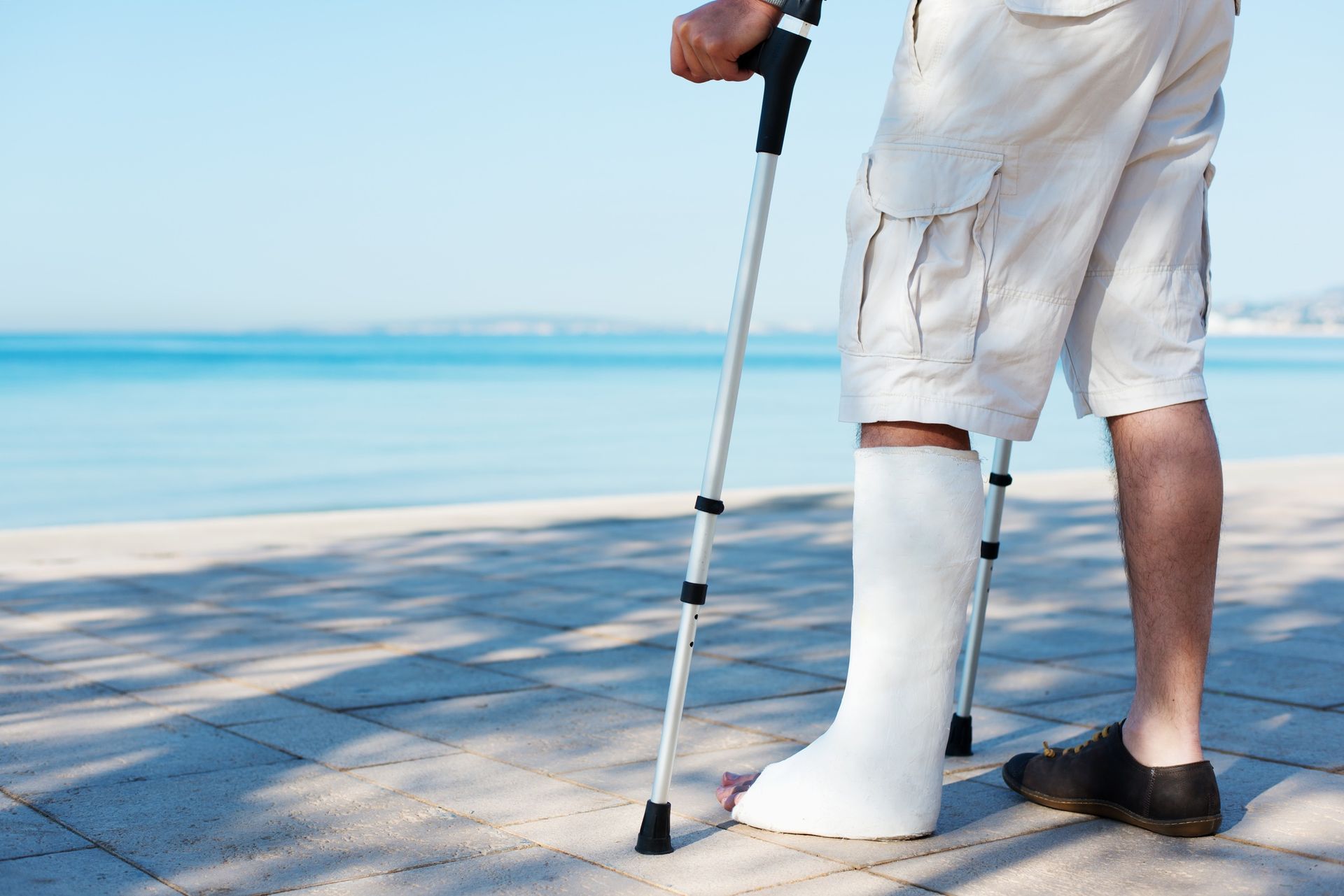 a man with a cast on his leg is using crutches