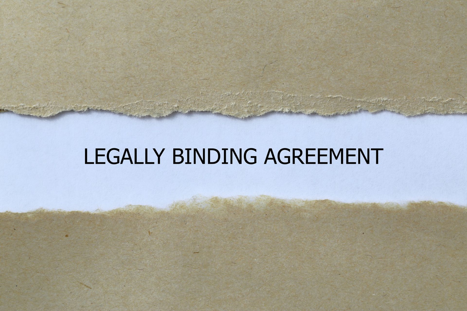 A piece of torn paper with the words legally binding agreement written on it