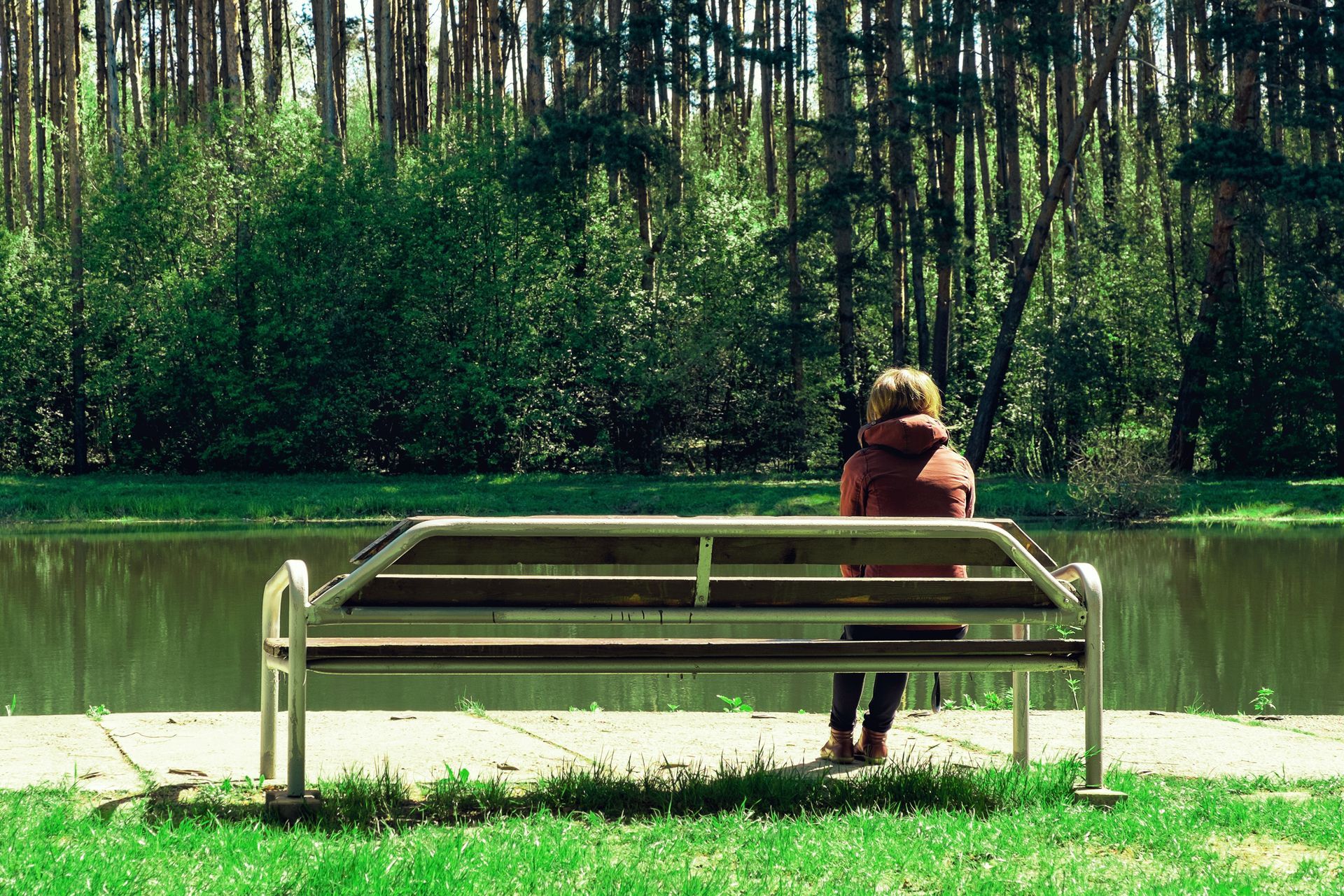 a woman sitting alone on a bench