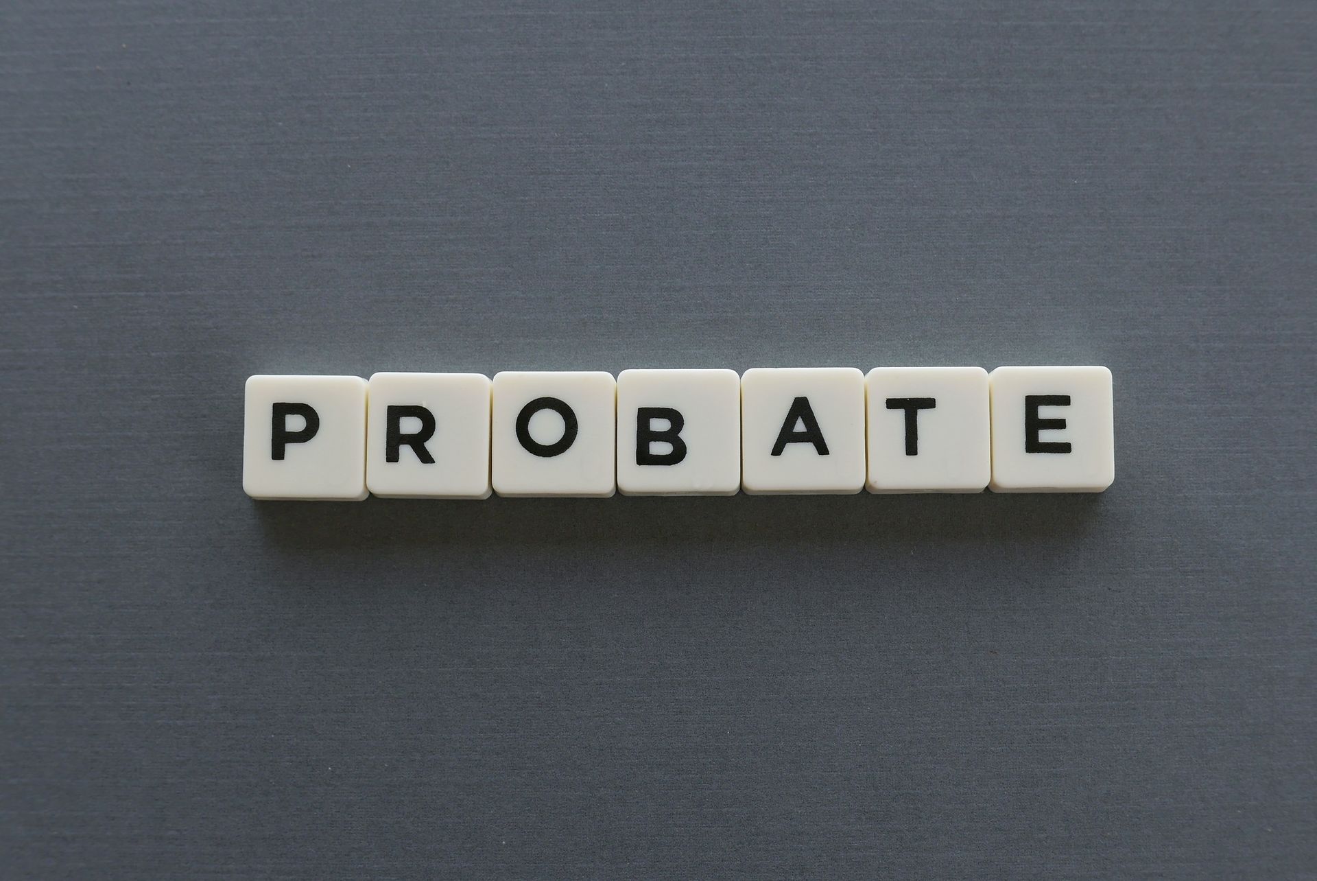 the word probate is written in scrabble tiles on a grey surface