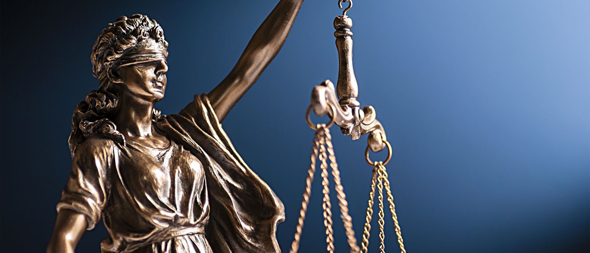 A statue of lady justice holding a pair of scales