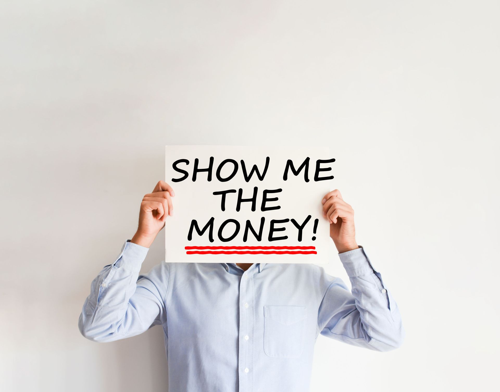 A man is holding a sign in front of his face that says 