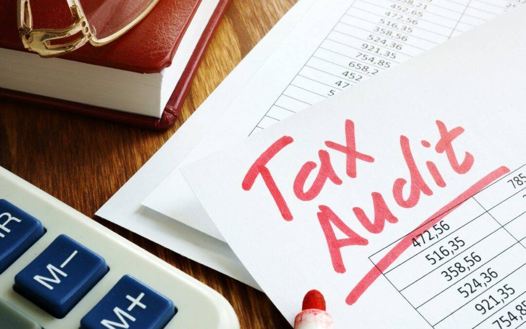 tax audit is written on a piece of paper next to a calculator
