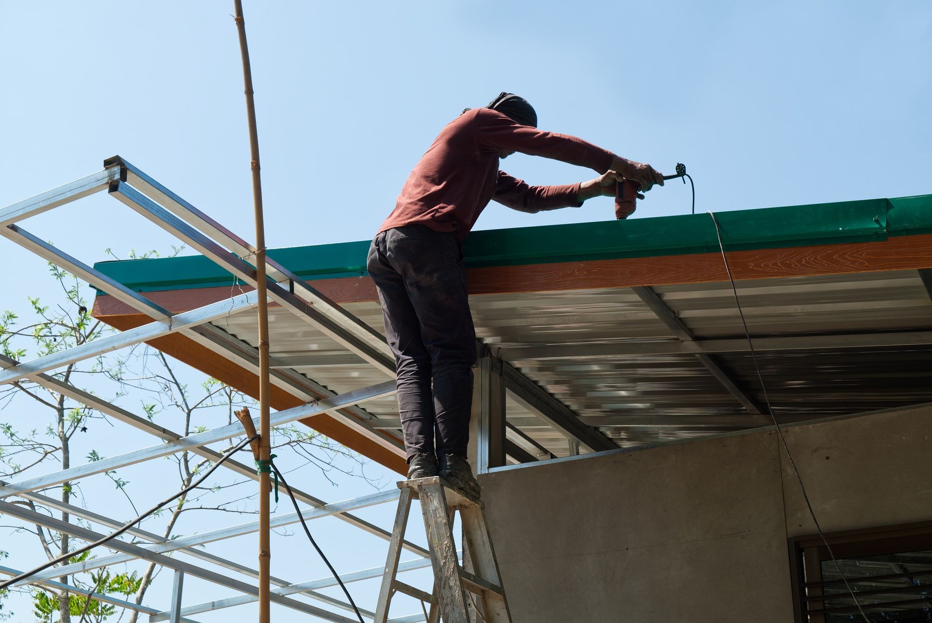 A man is working on the roof of a building.