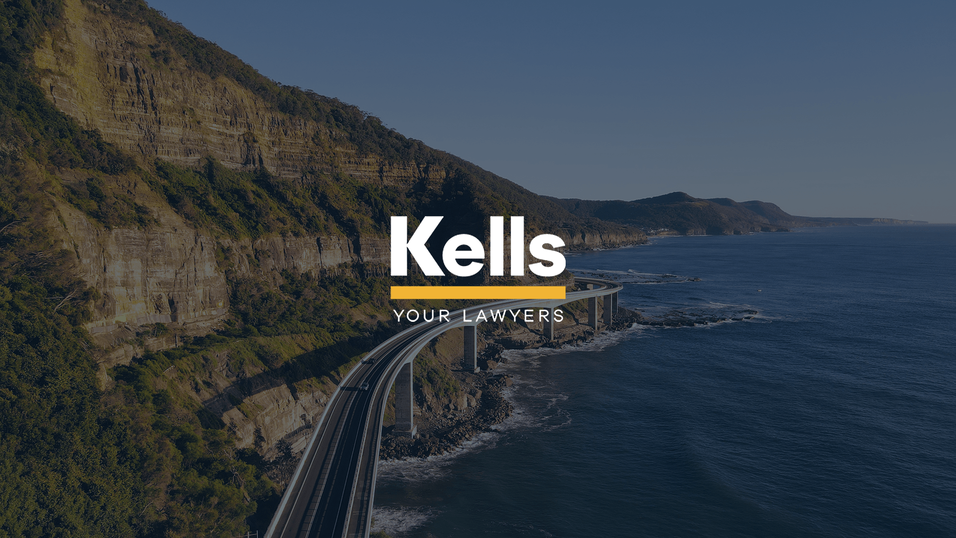 Beautiful Sea Cliff Bridge vista featuring the Kells the Lawyers emblem