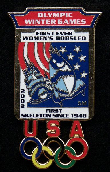 A pin that says olympic winter games first ever women 's bobsled