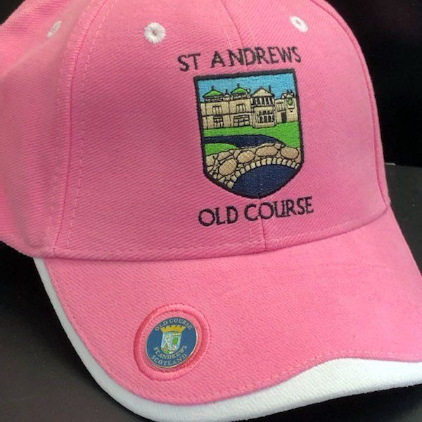 A pink hat that says st andrews old course