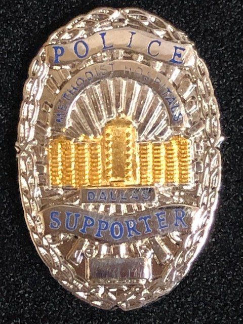 A badge that says police supporter on it