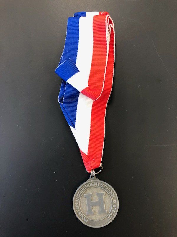 A medal with the letter h on it