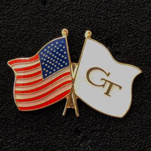 A pin with an american flag and a white flag with the letter gt on it