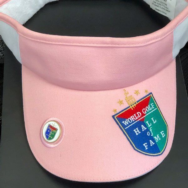 A pink visor that says world golf hall of fame
