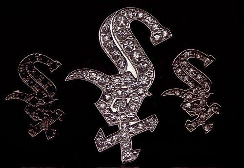 The letter s is surrounded by diamonds on a black background